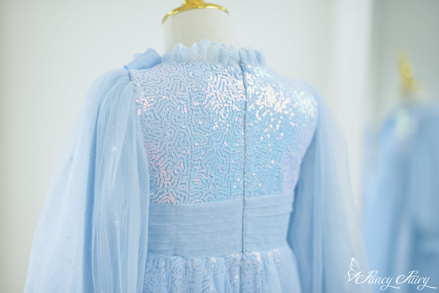 Back of dress with pleated waistband and glittery bodice.