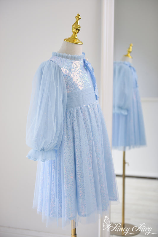 Side view showing tulle puff sleeves and elegant A-line shape.