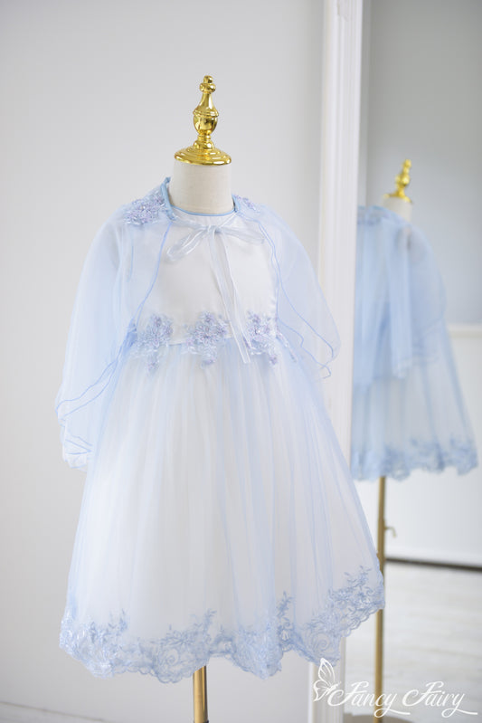 Full-length view of the dress from side angle, highlighting flowing cape.