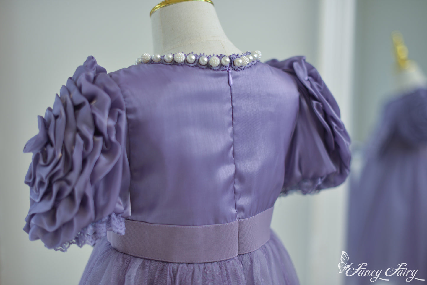 Back view showing zipper closure and gathered waist fit.