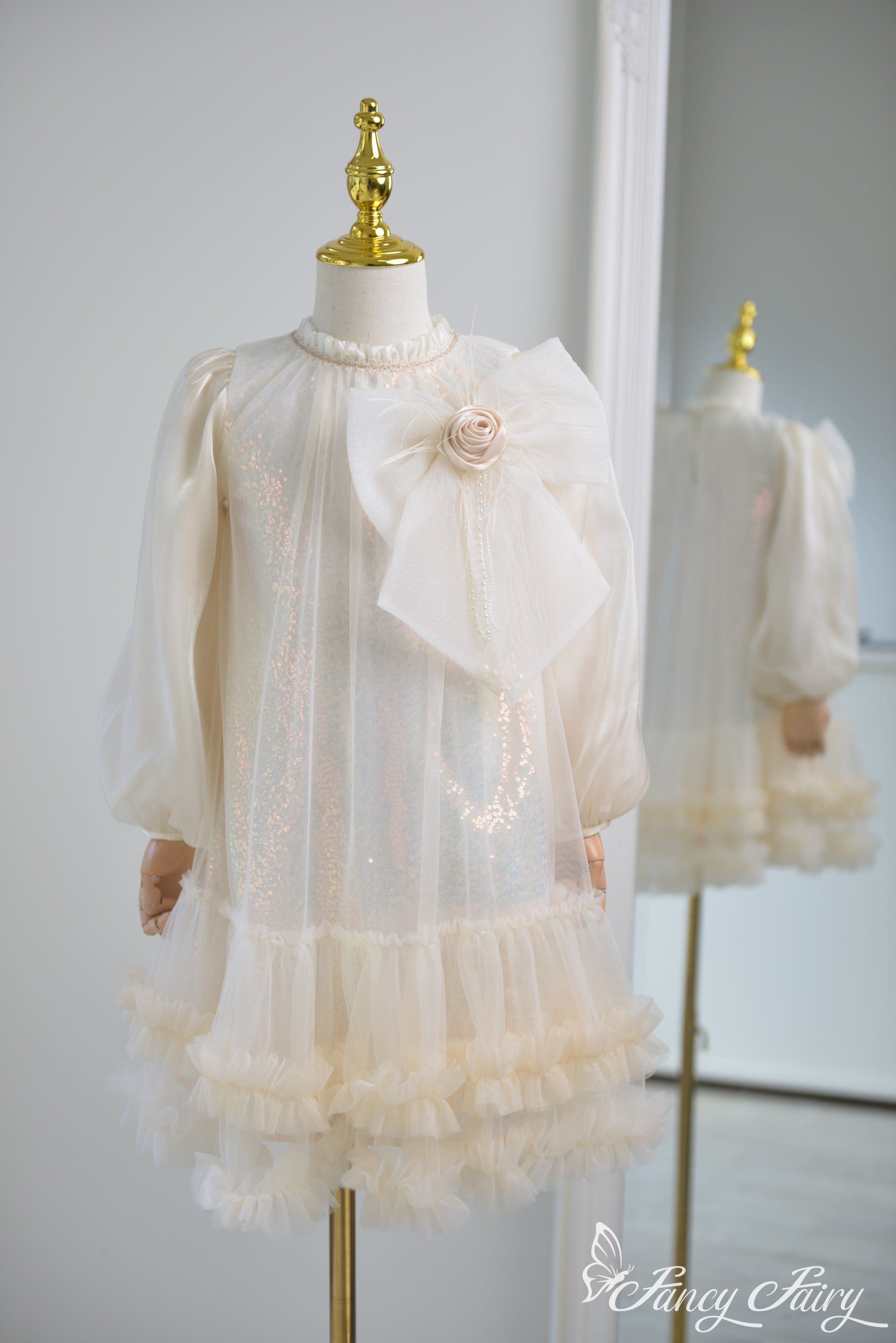 Front view of apricot girls' dress with large bow and ruffled hem – Fancy Fairy