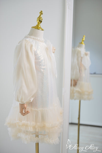 Side view showing puff sleeves and glittery tulle skirt.