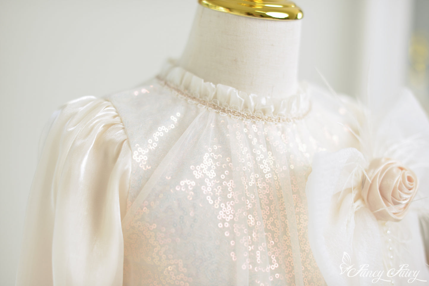 Zoom-in of sequin sparkle on apricot mesh.