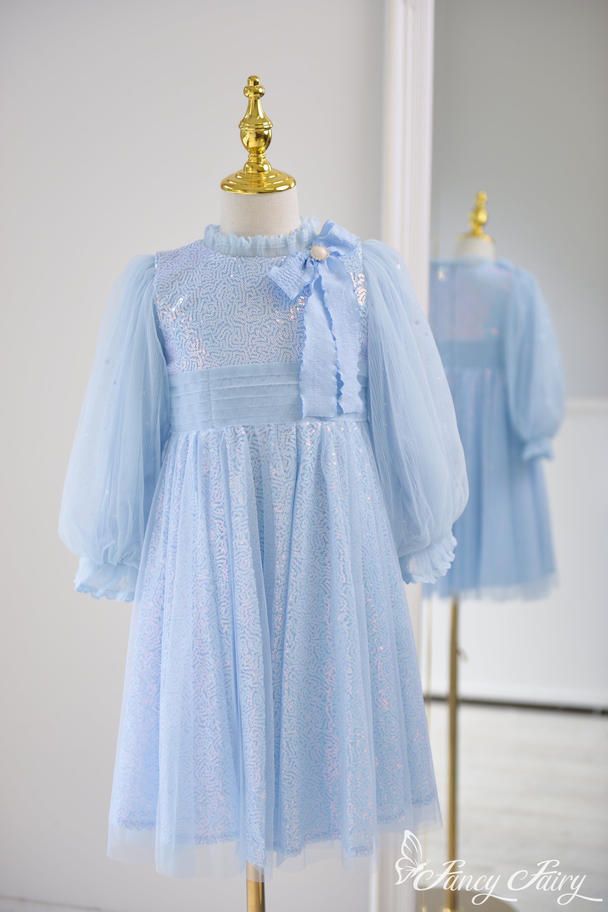 Front view of girls princess birthday light blue Elsa-inspired dress with sequin bodice, long puff sleeves, and chiffon bow – Fancy Fairy