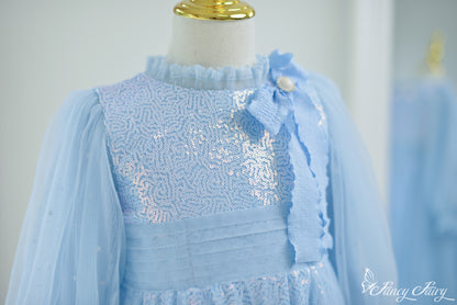 Zoom-in left side of glitter tulle skirt in Frozen-style blue tones.