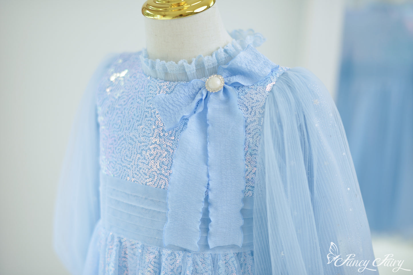 Zoom-in right side of glitter tulle skirt in Frozen-style blue tones.