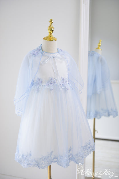 Full-length view of the dress from side angle, highlighting flowing cape.