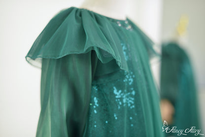 Shoulder angle of flutter sleeve and glistening mesh overlay.