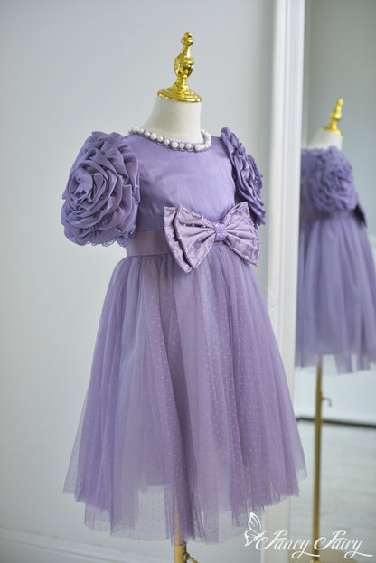 Side detail of sculpted floral sleeve and soft mesh skirt layers.