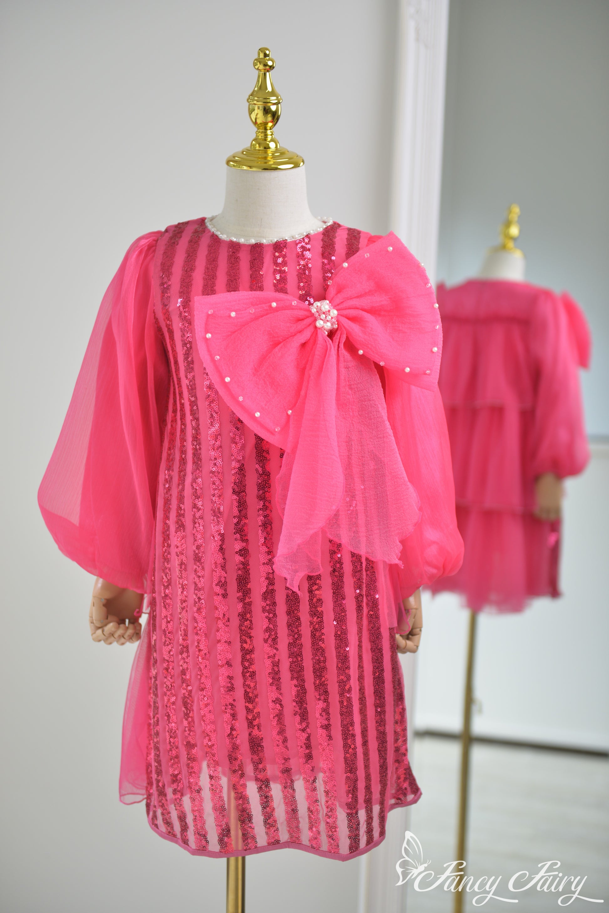 Front view of hot pink sequin dress with large pearl bow and sheer puff sleeves - Fancy Fairy