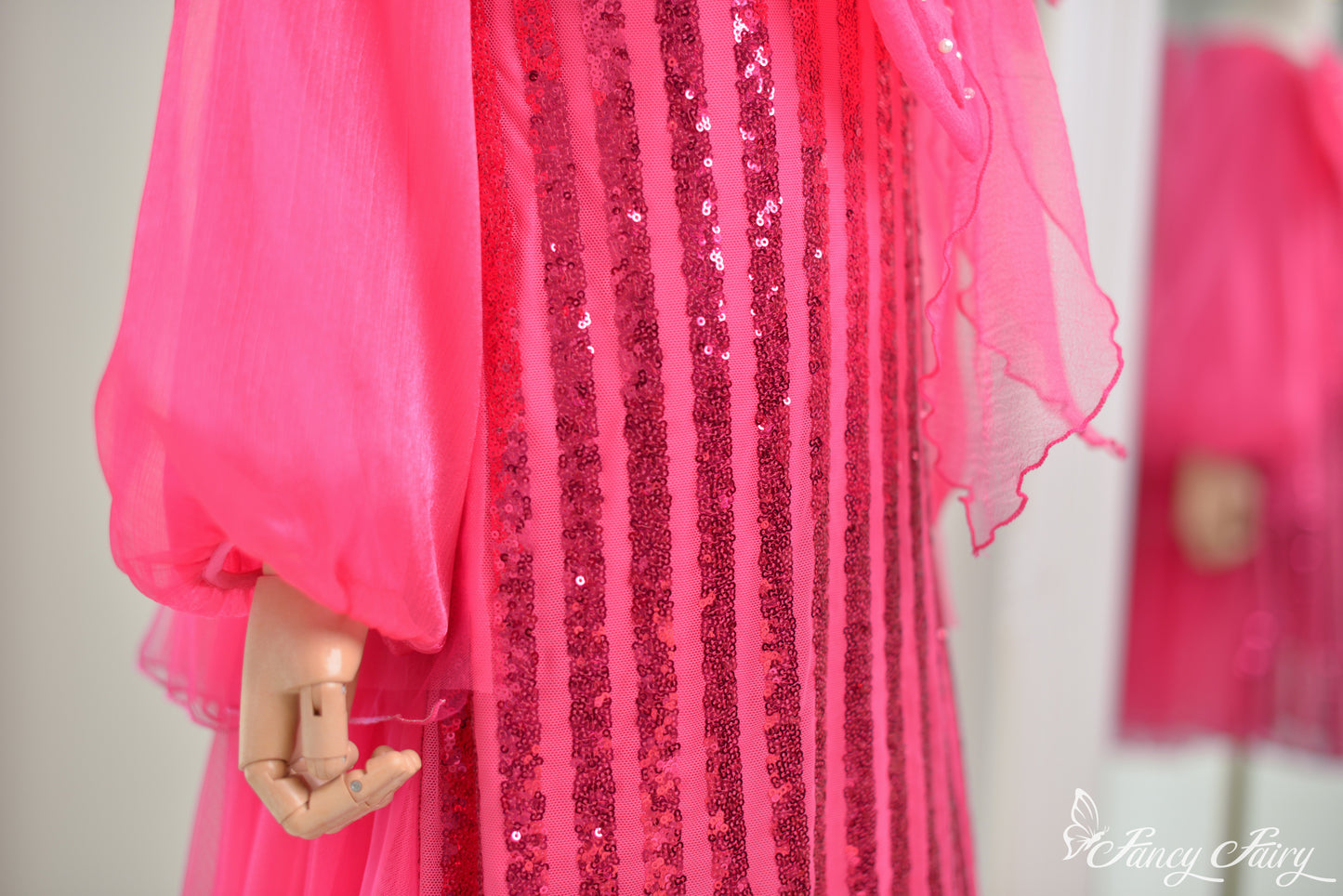 Close-up of pink vertical sequin stripes.