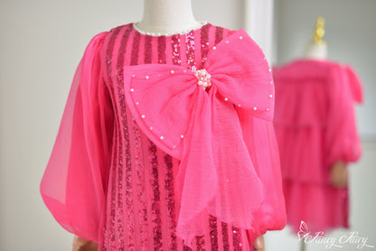 Close up of sequin stripes and pink bow with pearls. 