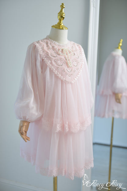 Side view of pink girls' lace dress with puff sleeves and pearl embroidery.