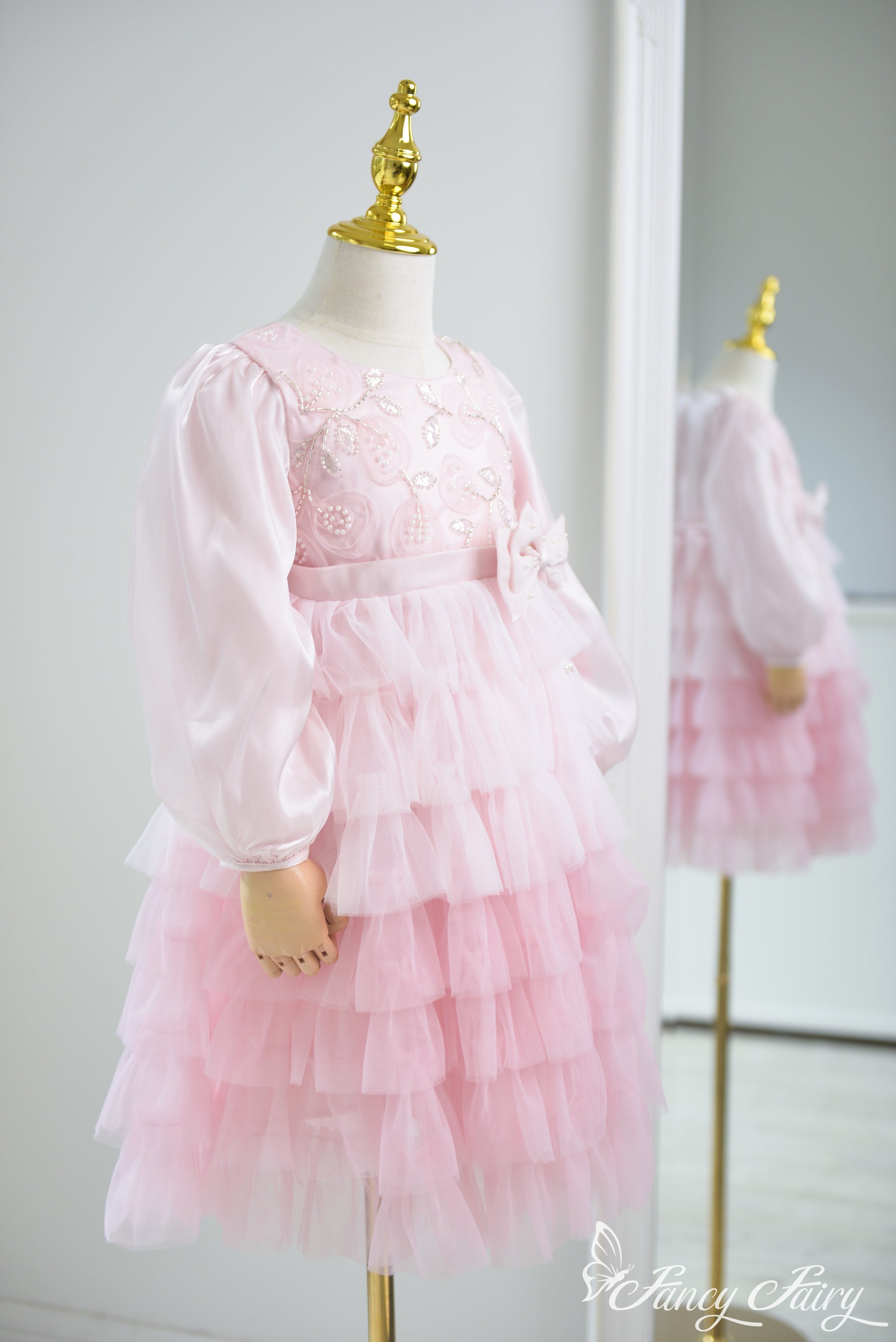 Side angle showing volume of the tiered skirt and puff sleeve structure.