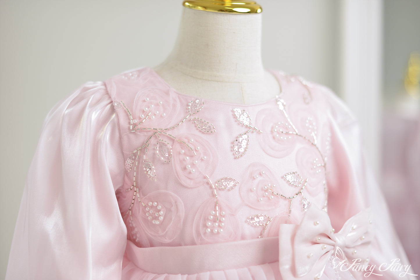 Detail shot of floral embroidery with pearls.