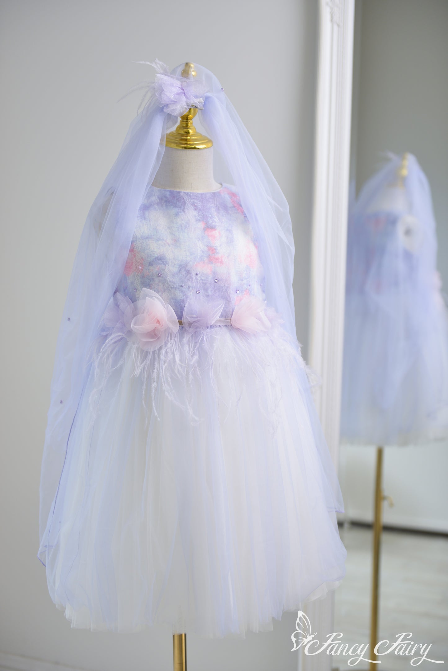 Full-body view of purple fairy dress with veil clipped to hair.