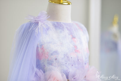 Close-up of upper bodice showing pastel ombré print and floral shoulder clip.