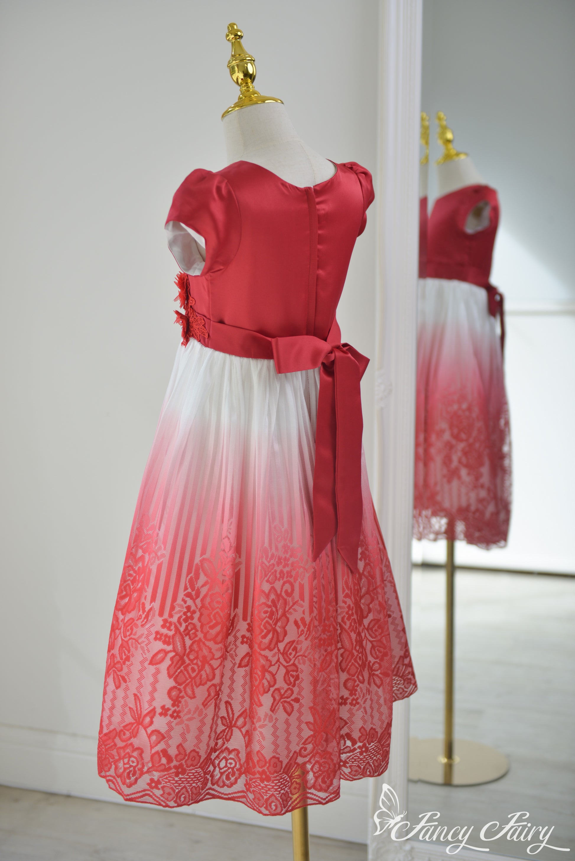Side angle showing flow of the red to white gradient lace dress with satin top.