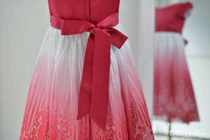 Back view of the dress featuring a red satin bow tie at the waist.