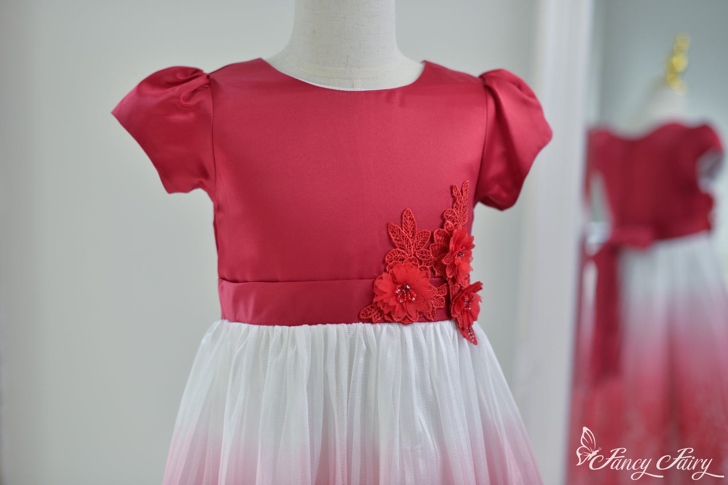 Angled view of the top half, highlighting red satin bodice and floral detail.