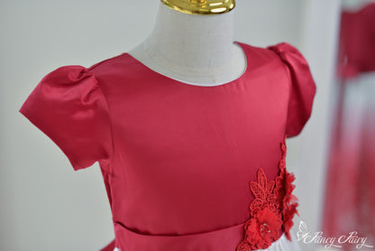 Angled view of the top half, highlighting red satin bodice and floral detail.