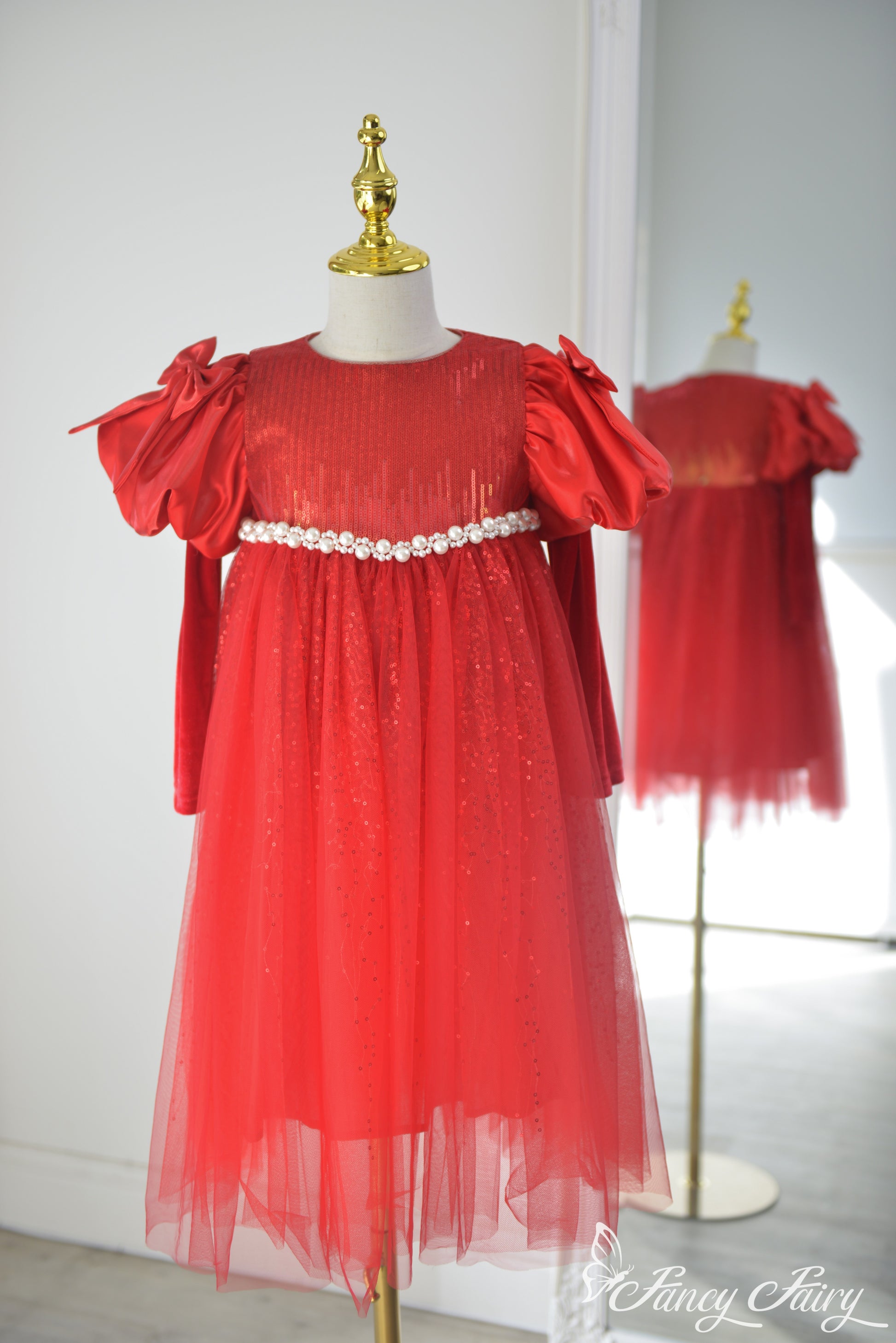 Front view of red sequin girls' dress with puff bow sleeves and pearl waist trim – Fancy Fairy