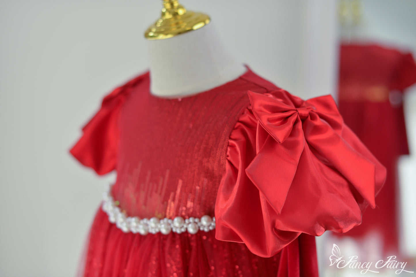 Close-up of right side of the dress showing bow sleeve.