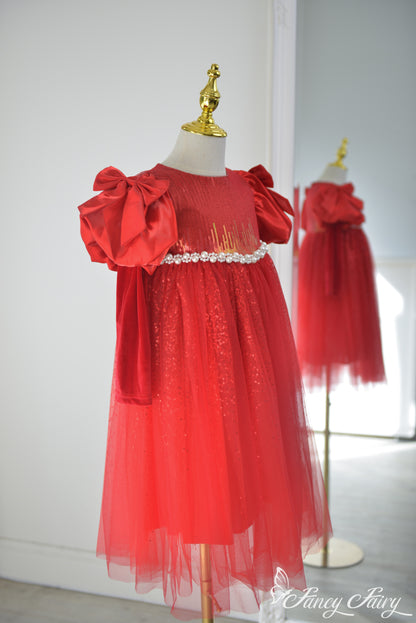 Side angle showing bow sleeves and layered sparkle texture.