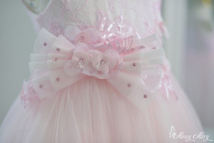 Close-up of sequin-pink flower bow detail with dotted tulle ribbon.