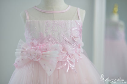 Front view of pink girls' dress with floral embroidery and double bow waist.
