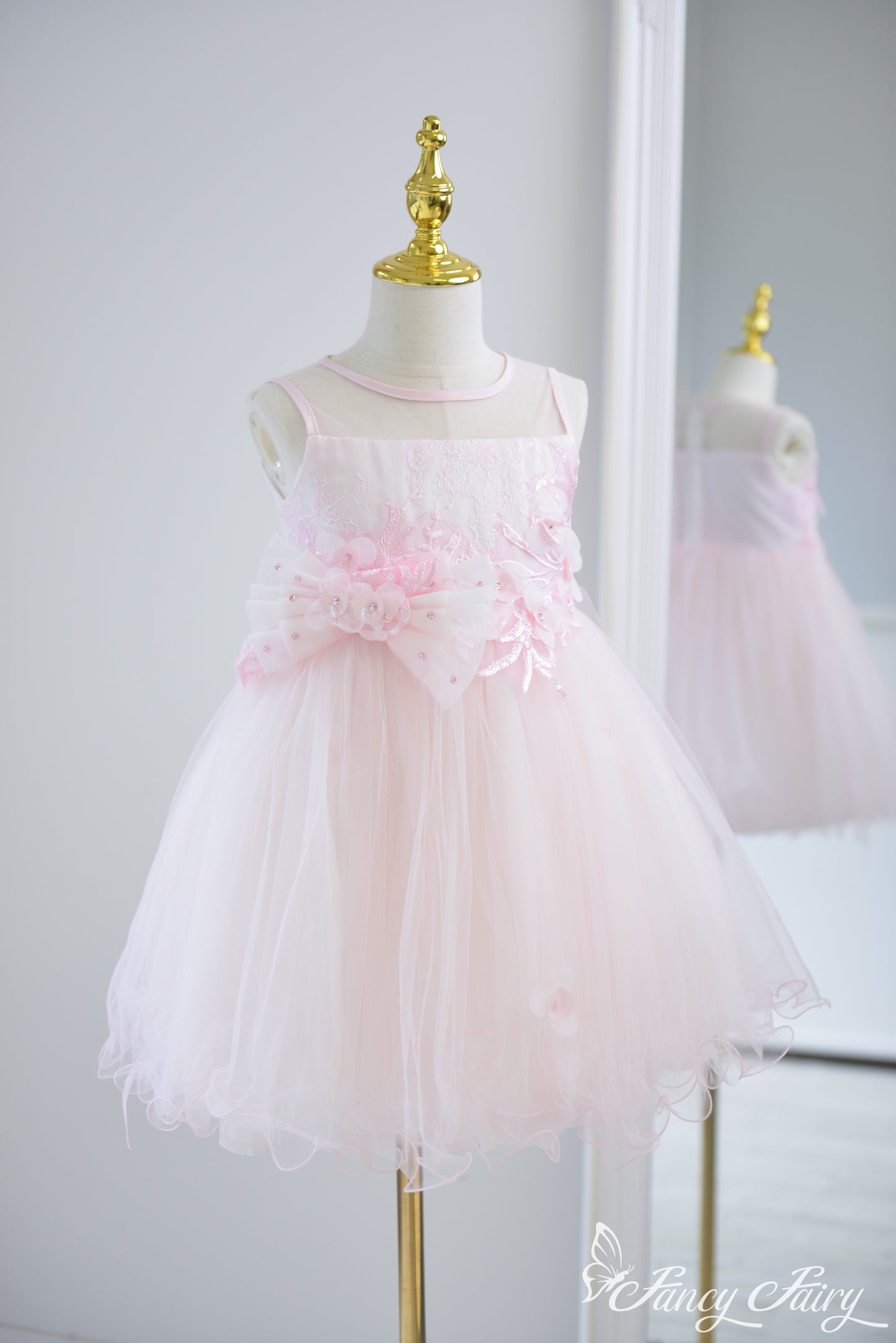 Angled view showing A-line shape and sparkly embroidered bodice.