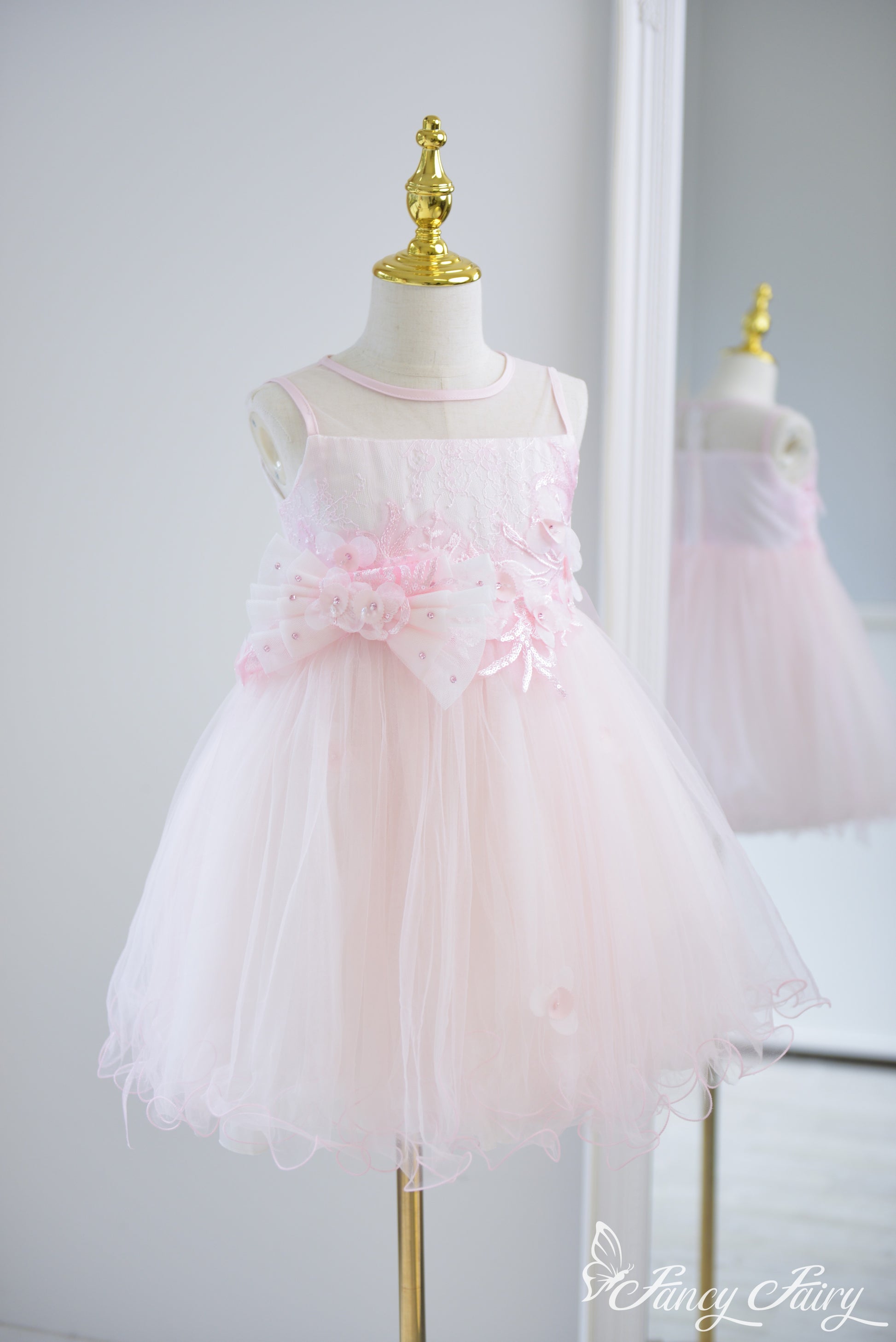 Angled view showing A-line shape and sparkly embroidered bodice.